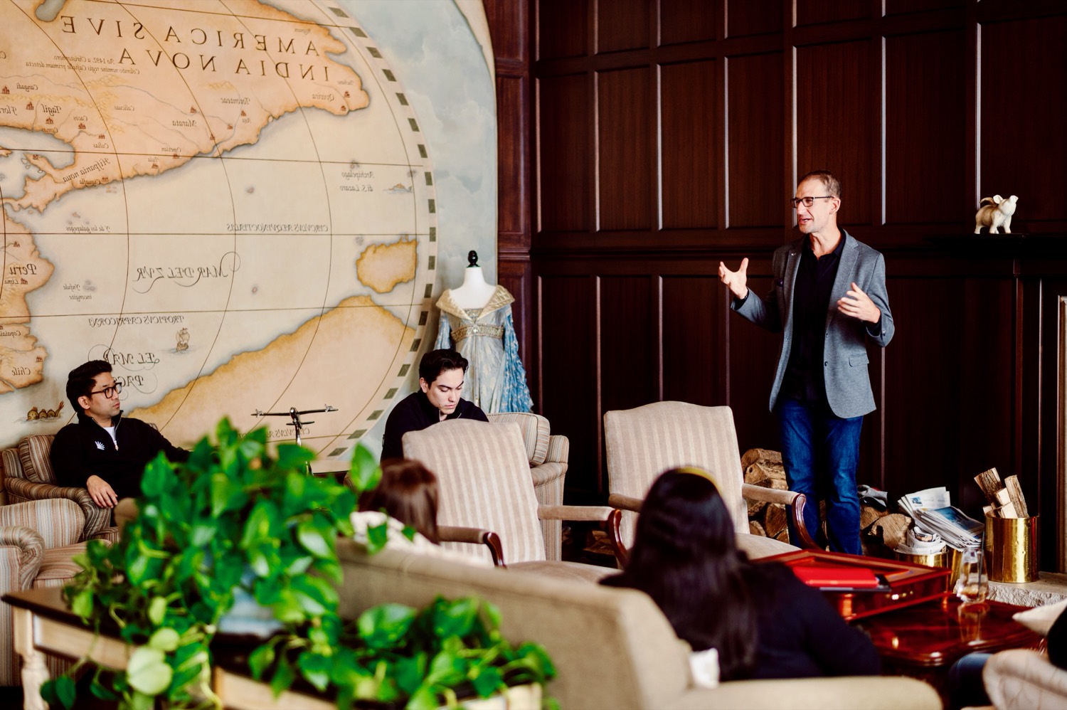 Ramy Nassar presenting in a panelled room